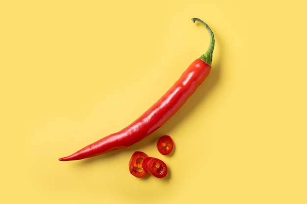 Free photo red hot chili peppers on yellow background