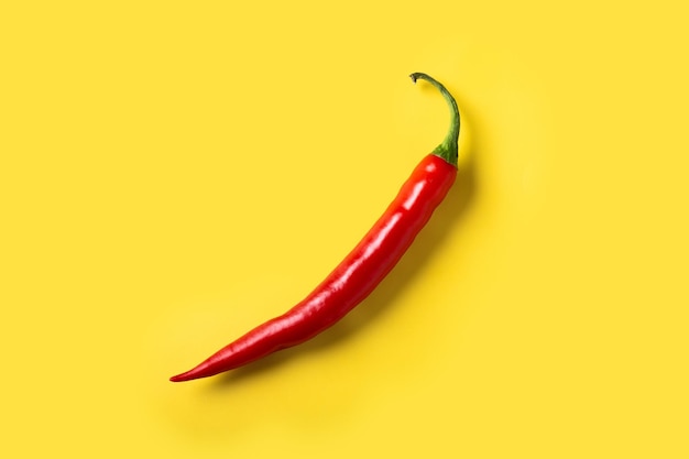 Free photo red hot chili peppers on yellow background