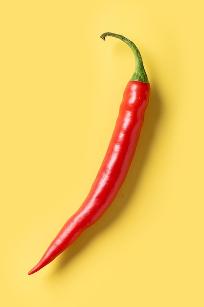 Red hot chili peppers on yellow background