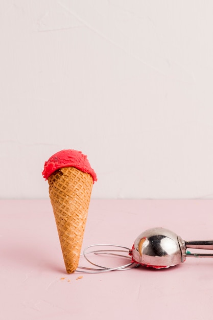 Free photo red ice cream cone with scooper