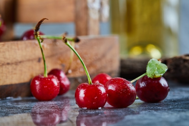 Red juicy cherry berries on a blue table