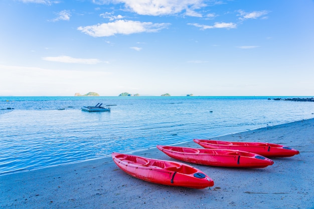 Red kayak on the tropical beach sea and ocean