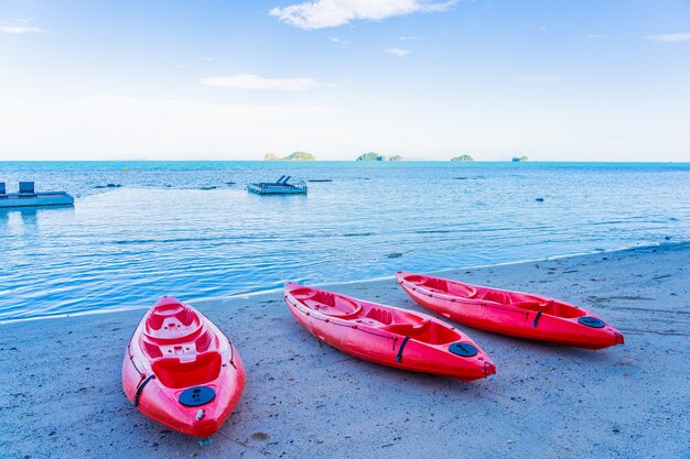 Red kayak on the tropical beach sea and ocean