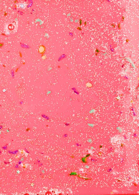 Free Photo red liquid with colourful crumbs