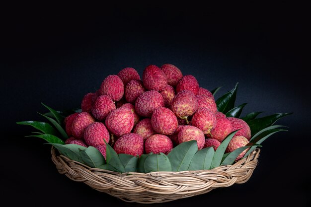 Free Photo red lychee fruit placed in a basket.