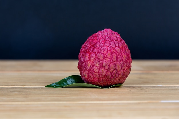 Free Photo red lychee fruit placed in a basket.