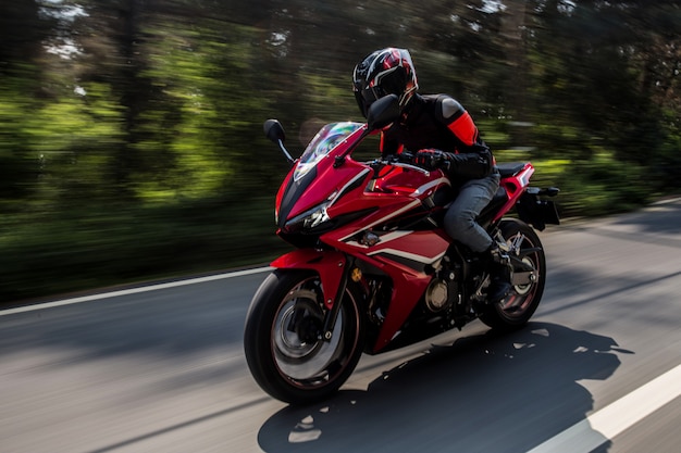 Red motor biking on the road.