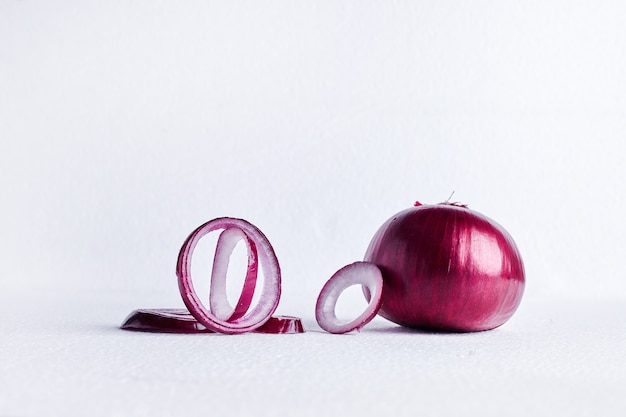 Red onion on a white table.