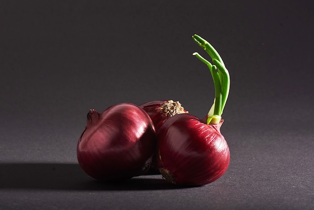 Red onions whole, isolated on a black