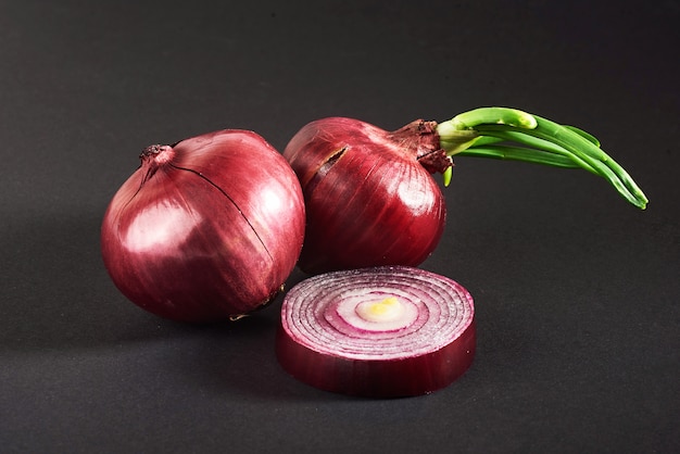 Free Photo red onions whole, isolated on a black.