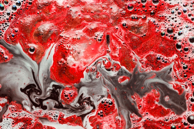 Free Photo red paint mixing with dirty water