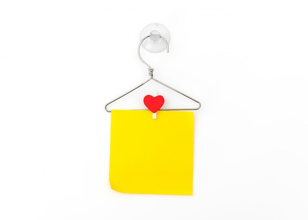 Free photo red paper heart hanging on white background .