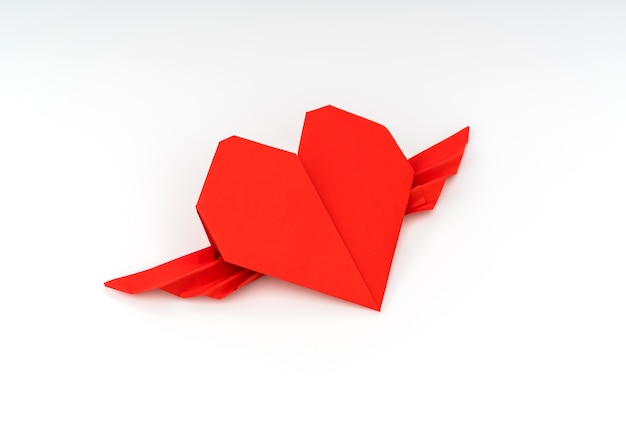 Red paper origami heart with wings on white background .