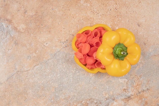 Free photo red pasta in bell pepper on orange background