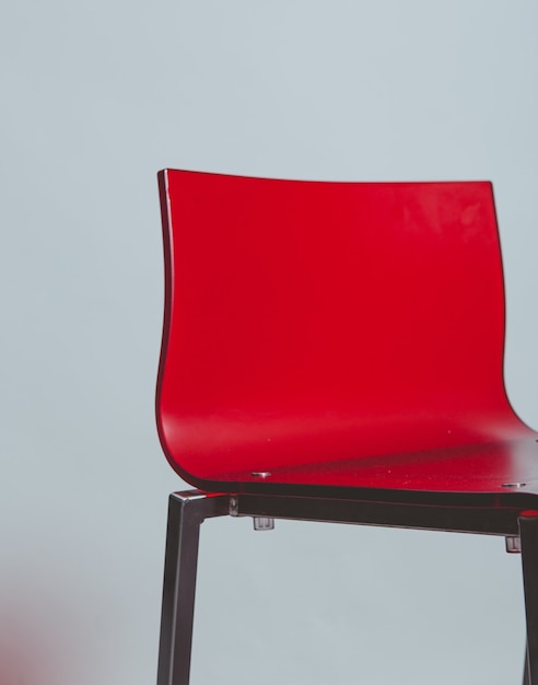 Free photo red plastic chair on white floor