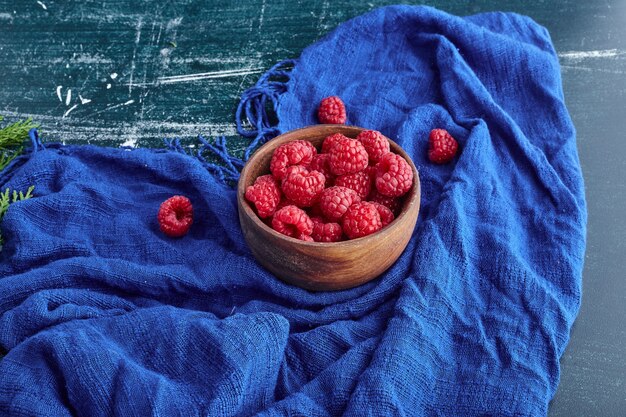 Red raspberries in a wooden bowl. 