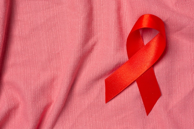 Free photo red ribbon hiv awareness concept world aids day and world sexual health day.