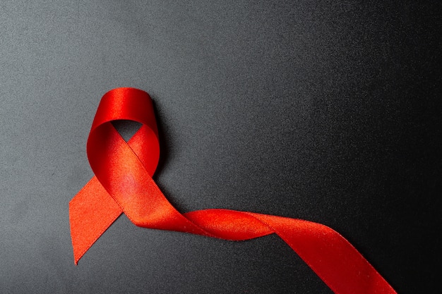 Free photo red ribbon hiv awareness concept world aids day and world sexual health day.