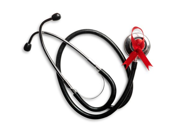 Red ribbon and stethoscope with white background. Hiv Aids ribbon awareness