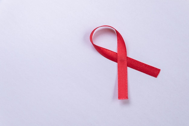 Red ribbon on white table