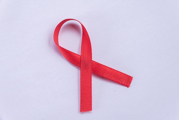 Red ribbon on white table