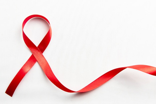 Free photo red ribbon with white background. hiv aids ribbon awareness