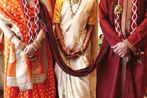 Red shawl connects bride's parents dressed for Indian wedding