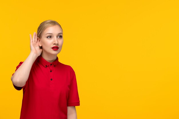 Red shirt day pretty girl eavesdropping in a red shirt on a yellow background