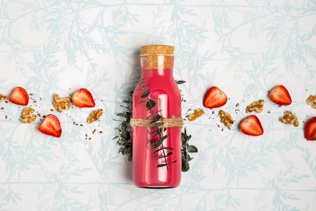 Free photo red smoothie with nuts seeds and strawberries