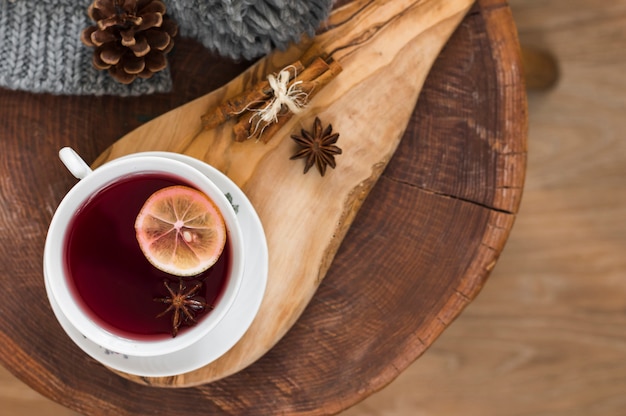 Red tea with lemon on wooden board