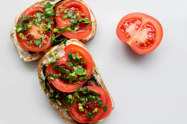 Red tomatoes delicious sandwiches with fresh vegetables and greens