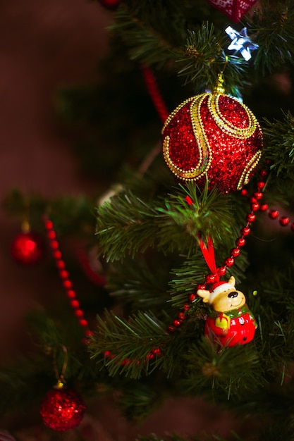 Free photo red toys hang on a christmas tree