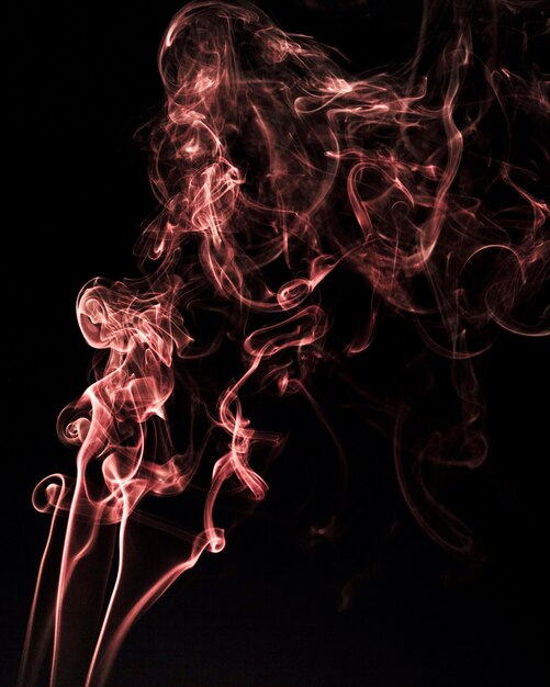 Red wavy smoke on black background