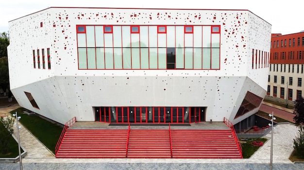 Free photo a red - white building with modern view and stairs in front of it in bucharest, romania