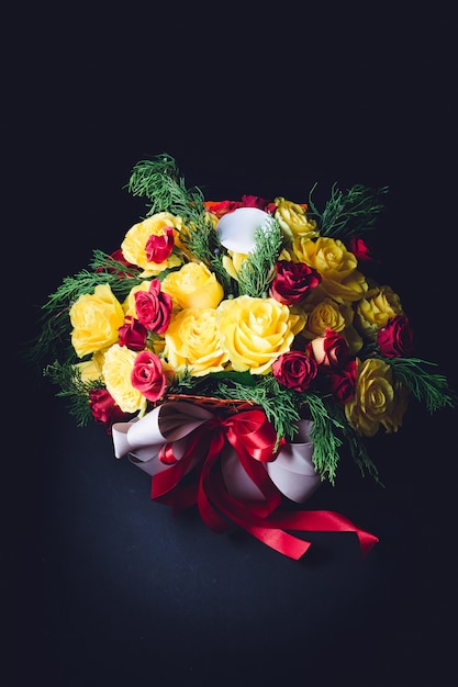 Free Photo red and white ribbons twine bouquet of red and yellow roses