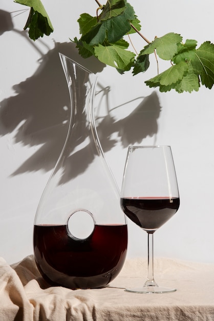 Free photo red wine carafe and glass arrangement