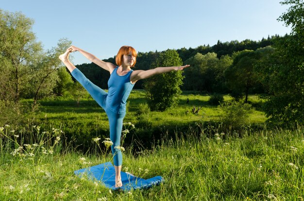 Red woman practicing fitness yoga