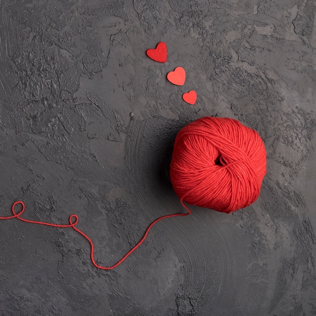 Free photo red wool ball on slate background