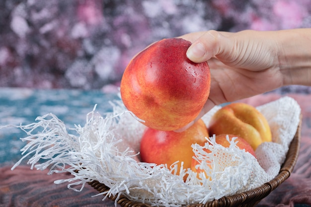 Free photo red yellow peach isolated on a piece of white towel.