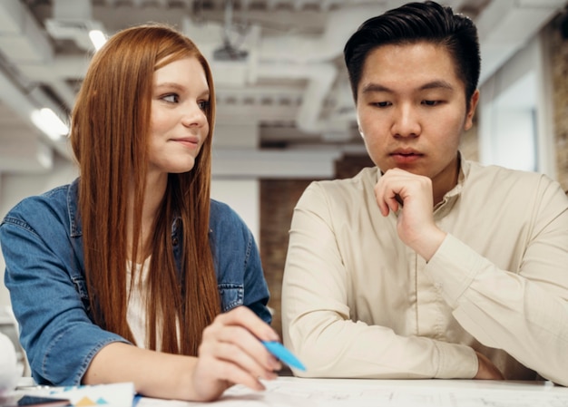 Redhead businesswoman discussing with her coworker