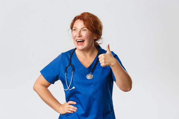 Redhead middle-aged nurse posing