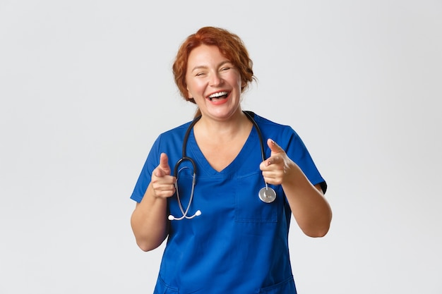 Redhead middle-aged nurse posing