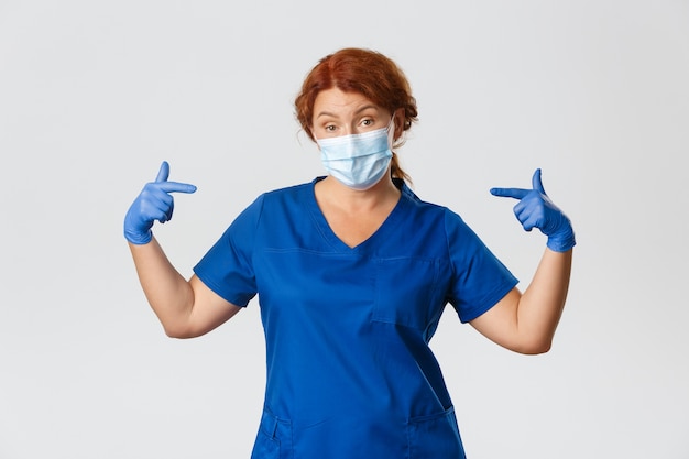 Free photo redhead middle-aged nurse posing