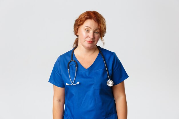 Redhead middle-aged nurse posing