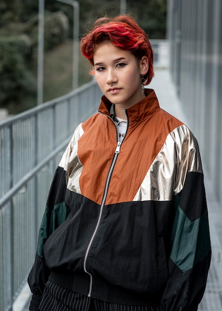 Free photo redhead non binary person wearing sports clothes outside