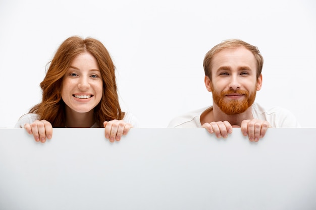 Redhead parents playing hide and seek, smile happy