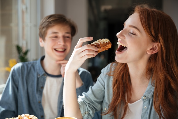 Redhead student eating dessert