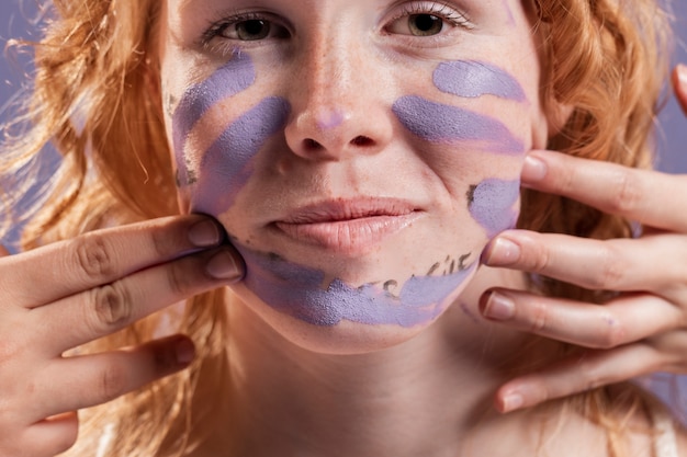 Free Photo redhead woman covered with purple paint