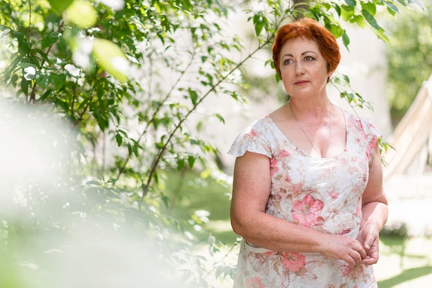 Redhead woman in floral dress looking away