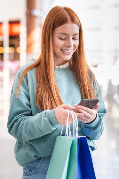 Free photo redhead woman looking on phone